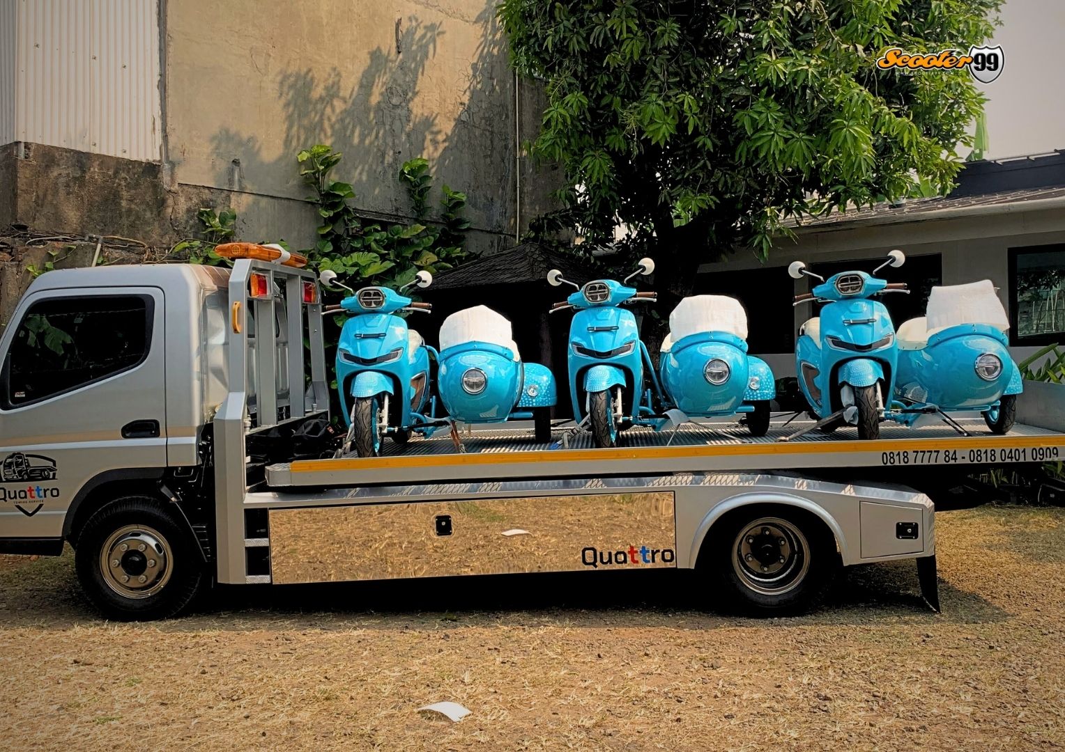 Classic Vespa being carefully secured onto a towing platform